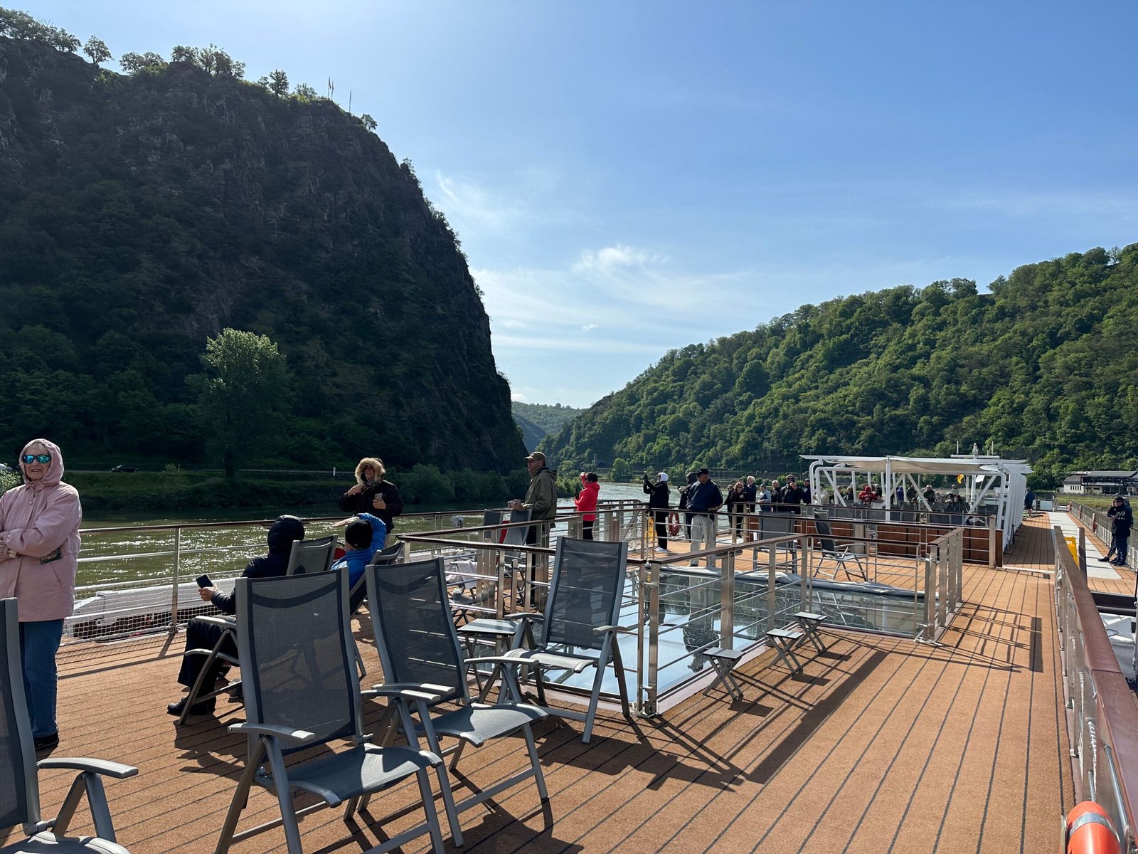 Passengers on a river cruise sun deck during scenic Rhine sailing